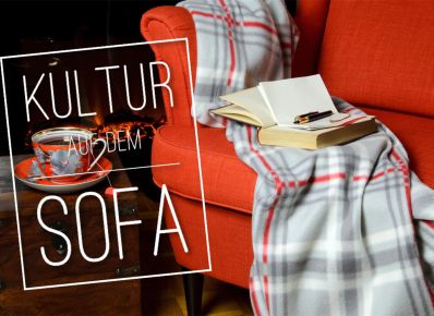 Sofa mit Decke und aufgeschlagenem Buch und dem Schriftzug "Kultur auf dem Sofa"